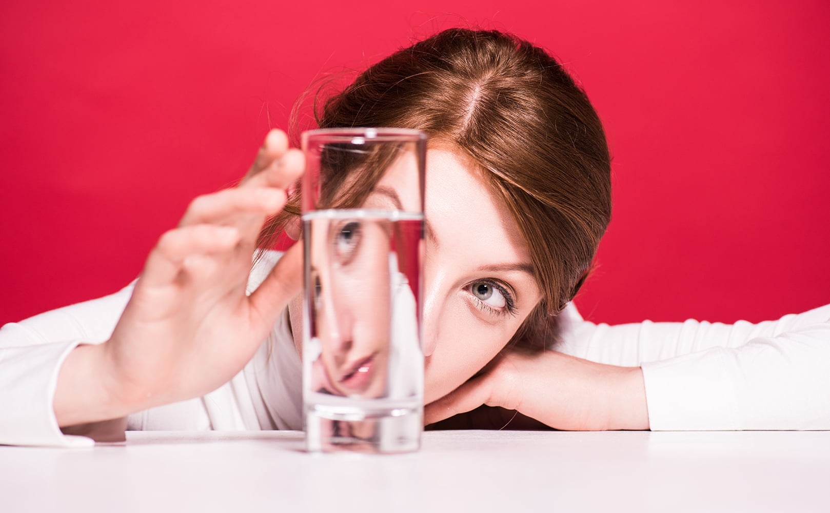 woman sitting in front of water glass